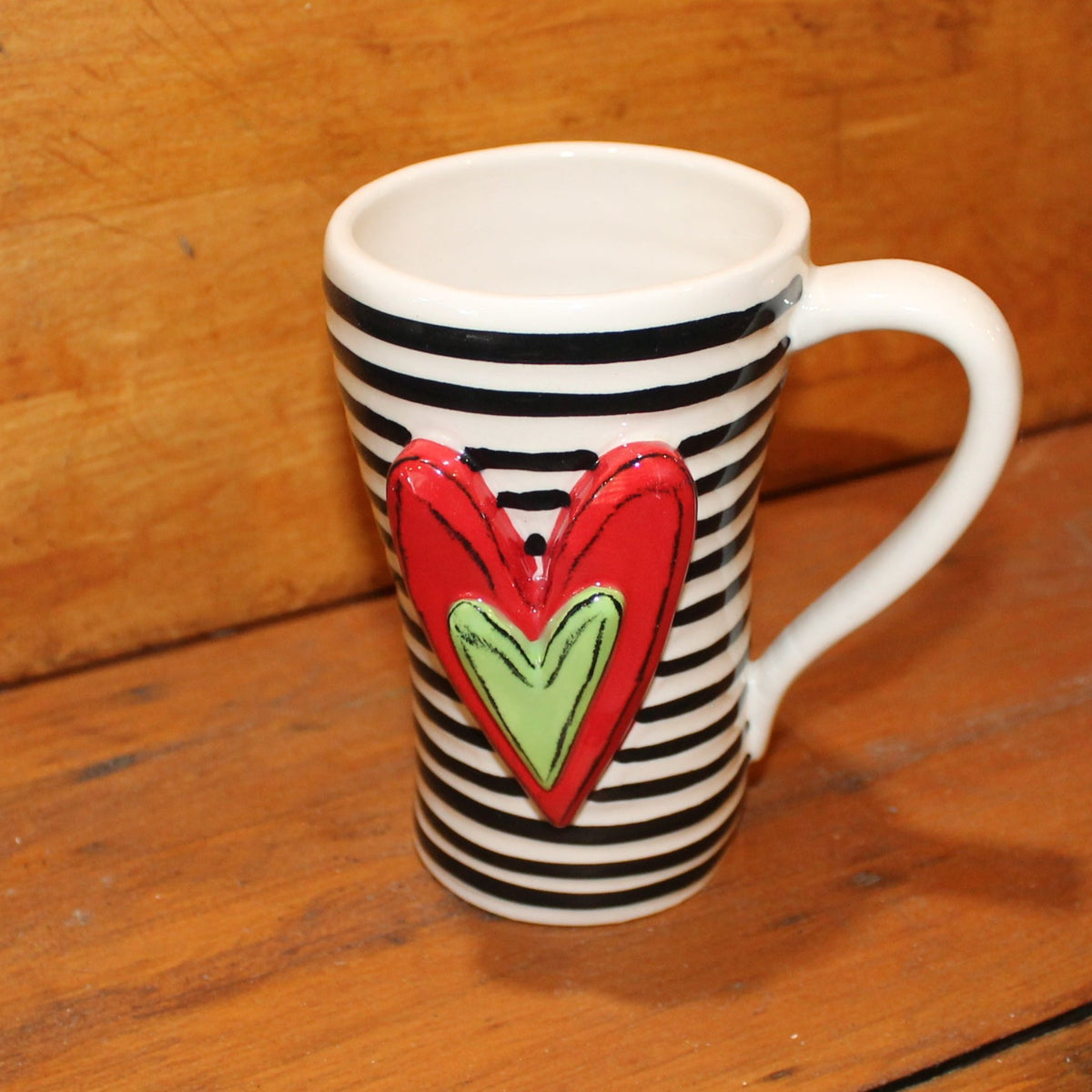 Unique, artful mugs with a cheery heart accent.