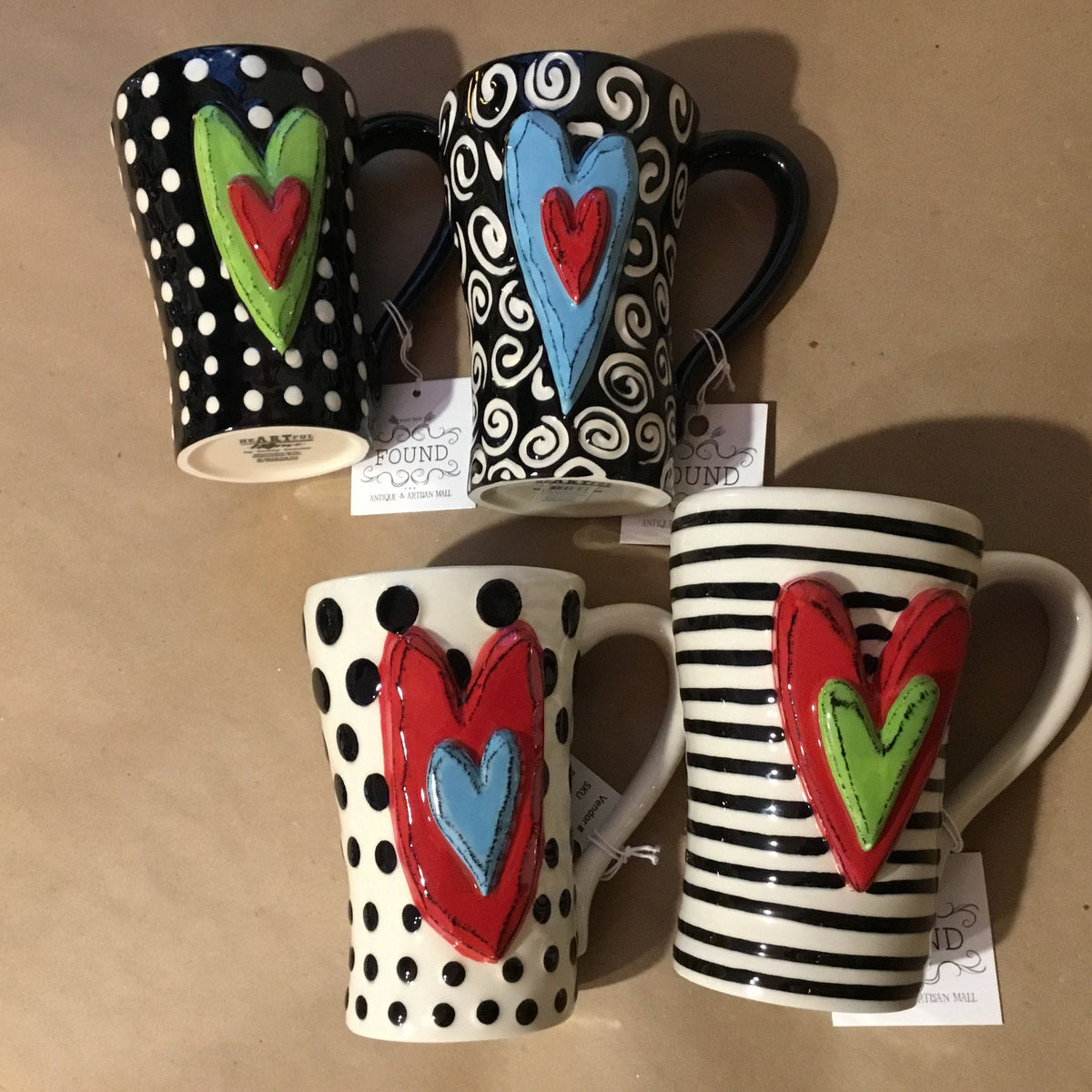 Unique, artful mugs with a cheery heart accent.